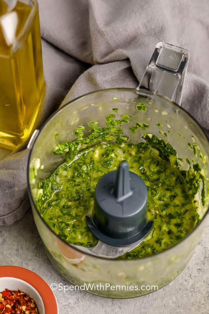 This chimichurri sauce adds bold, bright flavor to any meal in no time. Parsley and oregano bring a rich herbal taste, balanced by garlic, onion, and a zesty oil-vinegar base with a hint of red pepper. It's perfect as a marinade for chicken or beef cuts like skirt or flank steak. For a twist, try adding cilantro. Chimichurri is a must-have that can elevate any dish. #spendwithpennies Chimichurri Sauce in a food processor