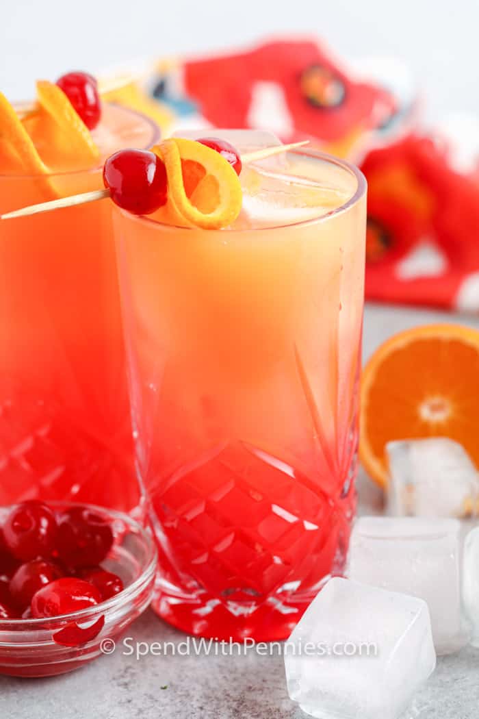 glasses of Tequila Sunrise with orange and cherry garnish