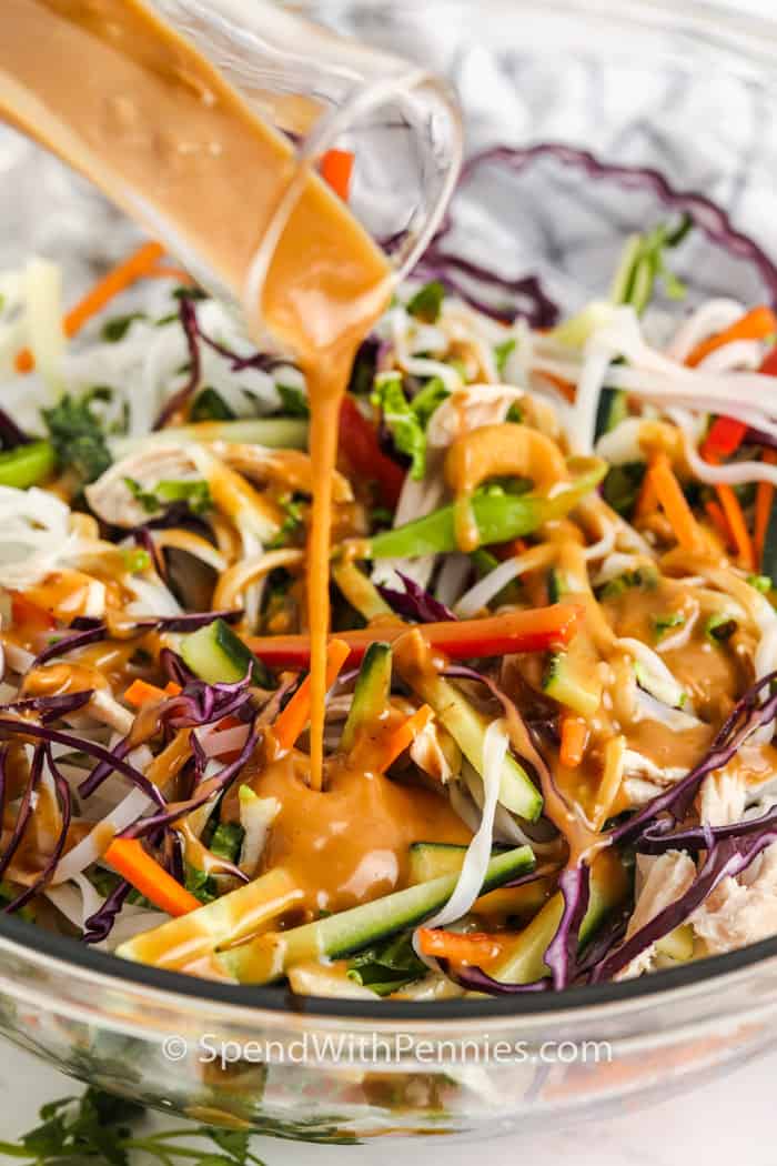 adding sauce to Sesame Ginger Noodle Salad