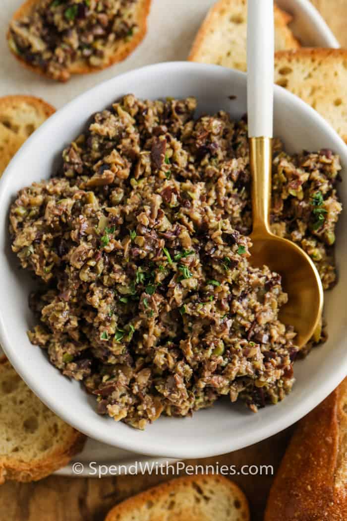 Tapenade in a dish with bread slices