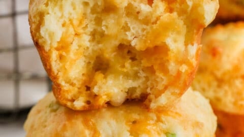 Cheese Muffins (Quick Bread) with one in half and butter on top