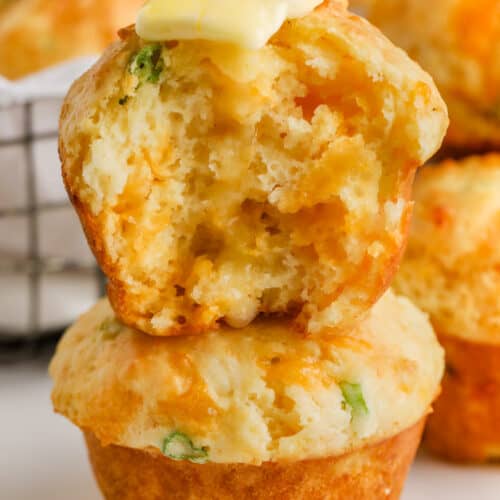 Cheese Muffins (Quick Bread) with one in half and butter on top