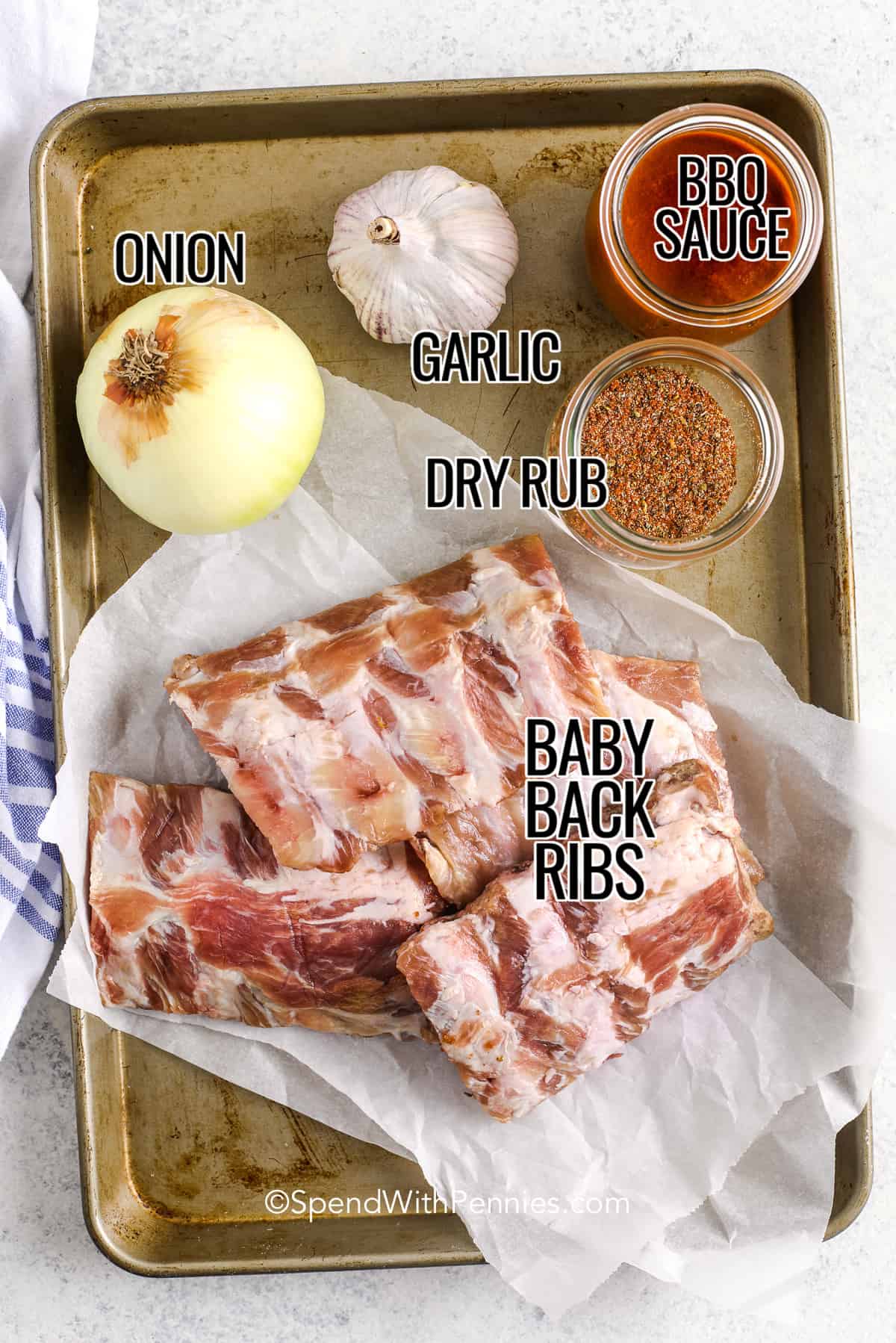 These oven-baked ribs are incredibly juicy and tender, practically falling off the bone! Coated in a homemade rib rub and smothered in your favorite BBQ sauce, they burst with flavor. Finish them off with a quick grill to seal in the goodness and indulge in these finger-licking ribs year-round. #ovenbakedribs #ribs #recipe #spendwithpennies ingredients for oven baked ribs