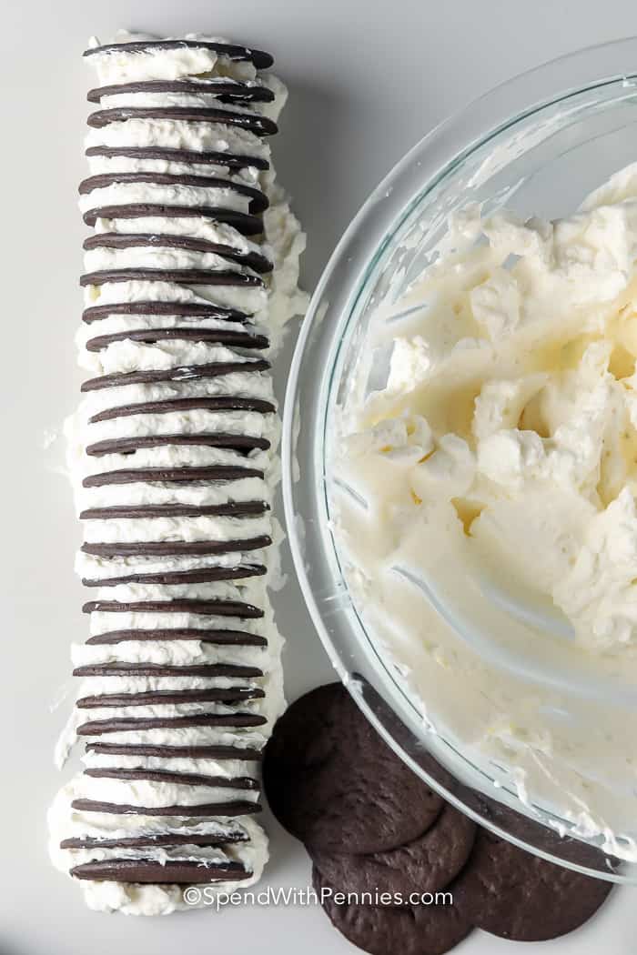 stack of wafers and icing next to a bowl of icing