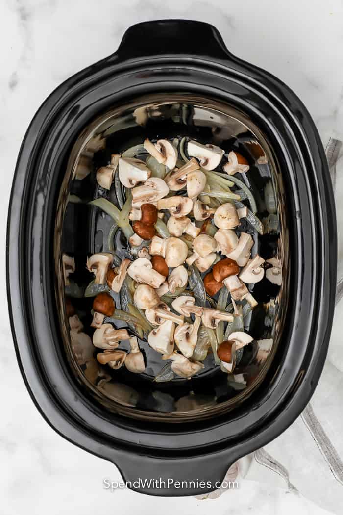 onions and mushrooms cooking in a crock pot