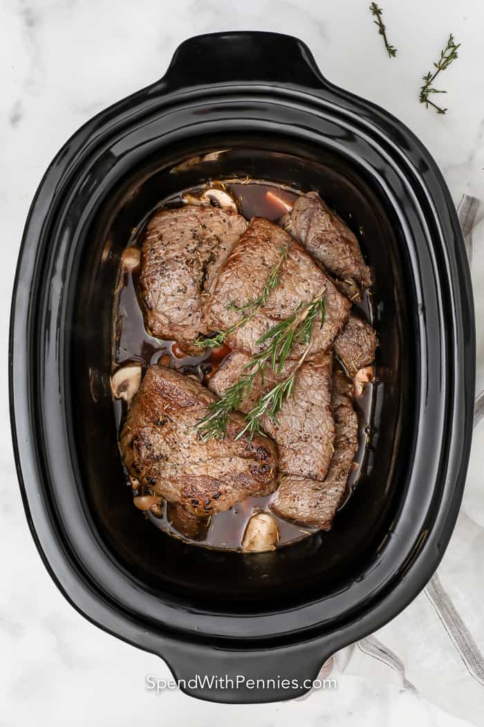 cooked steak in a crock pot