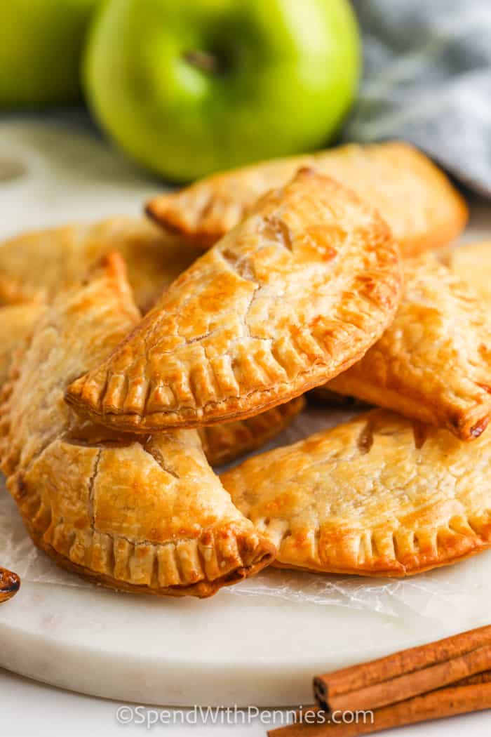 plated Apple Hand Pies with an apple in the back