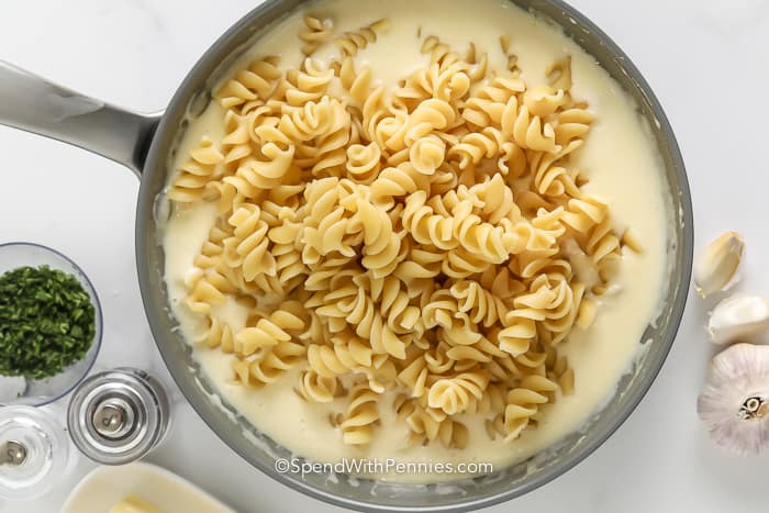 pasta in a pan with creamy garlic sauce