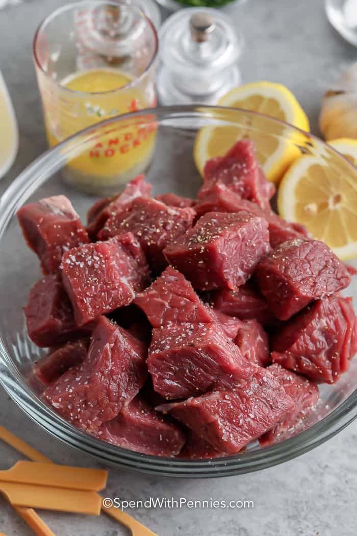Garlic steak kabobs are a delicious combination of marinated steak and grilled onions, offering a flavorful and satisfying meal option for outdoor gatherings and barbecues. With tender meat infused with garlic goodness and the charred flavors from the grill, these kabobs are sure to please both taste buds and appetites. #garlicsteakkabobs #steakkabobs #grilled #spendwithpennies raw steak cut into cubes