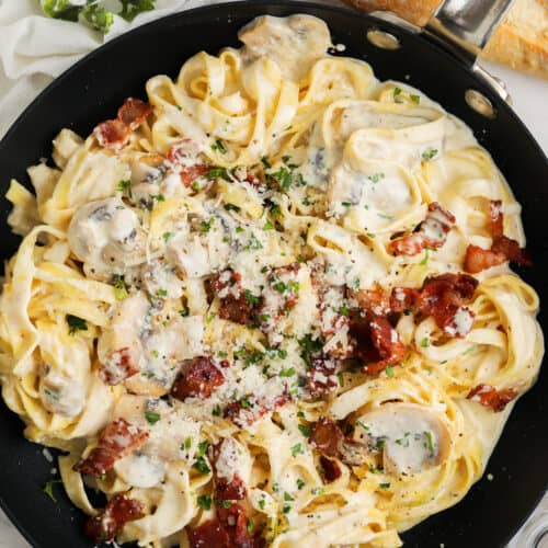 top view of Creamy Mushroom Pasta with Bacon in the pan with cheese