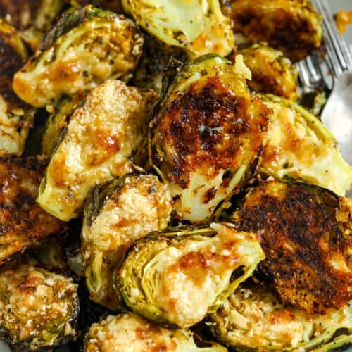 Parmesan Brussel Sprouts in a bowl with utensils