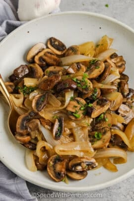 plated Buttery Fried Onions and Mushrooms with a spoon