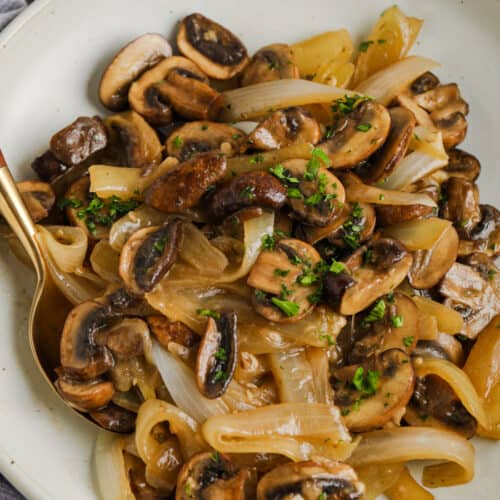 plated Buttery Fried Onions and Mushrooms with a spoon
