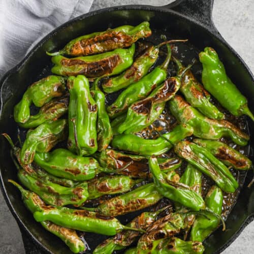 top view of Hot Honey Blistered Shishito Peppers cooked in the pan