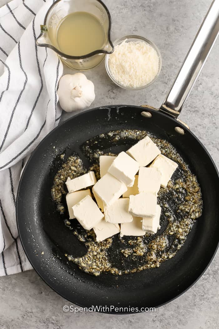 adding cream cheese to pan to make Cream Cheese Pasta Sauce