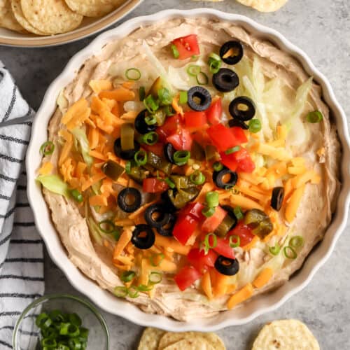 plated Easy Taco Dip with a bowl of chips beside it