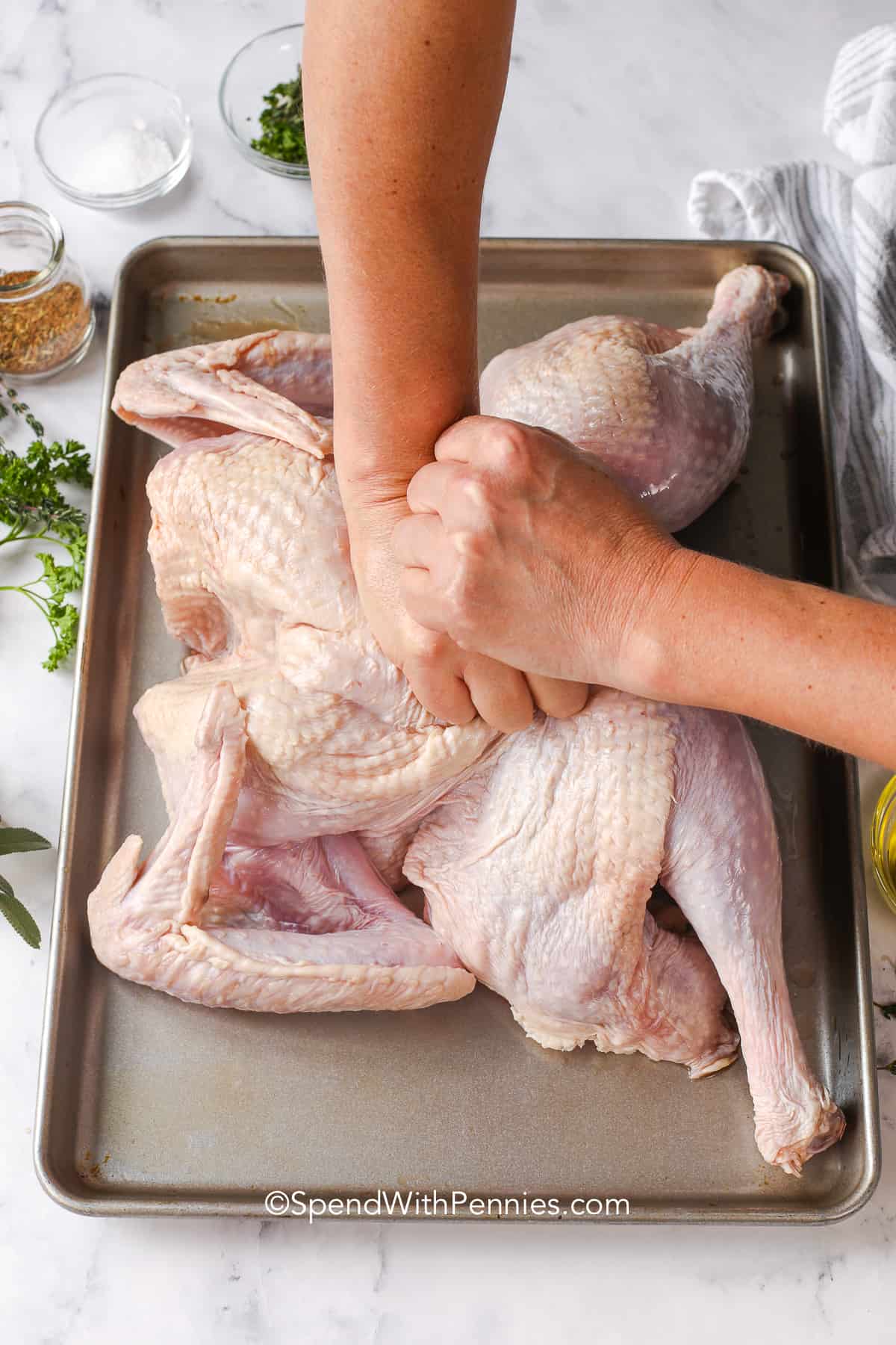 Spatchcock turkey is a classic way to roast a bird that stays moist inside and crispy on the outside. By pressing the turkey flat, it cooks evenly and keeps all the rich flavor. Olive oil, herbs, and a touch of seasoning make it simple yet delicious. This recipe is great for a 10 to 12 lb turkey and fits any family dinner or celebration. Use the drippings for gravy and enjoy every bite. #spendwithpennies flattening the breast bone of a turkey to flatten it