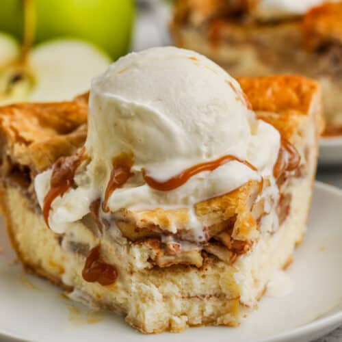 piece of Cheesecake Apple Pie on a plate with ice cream
