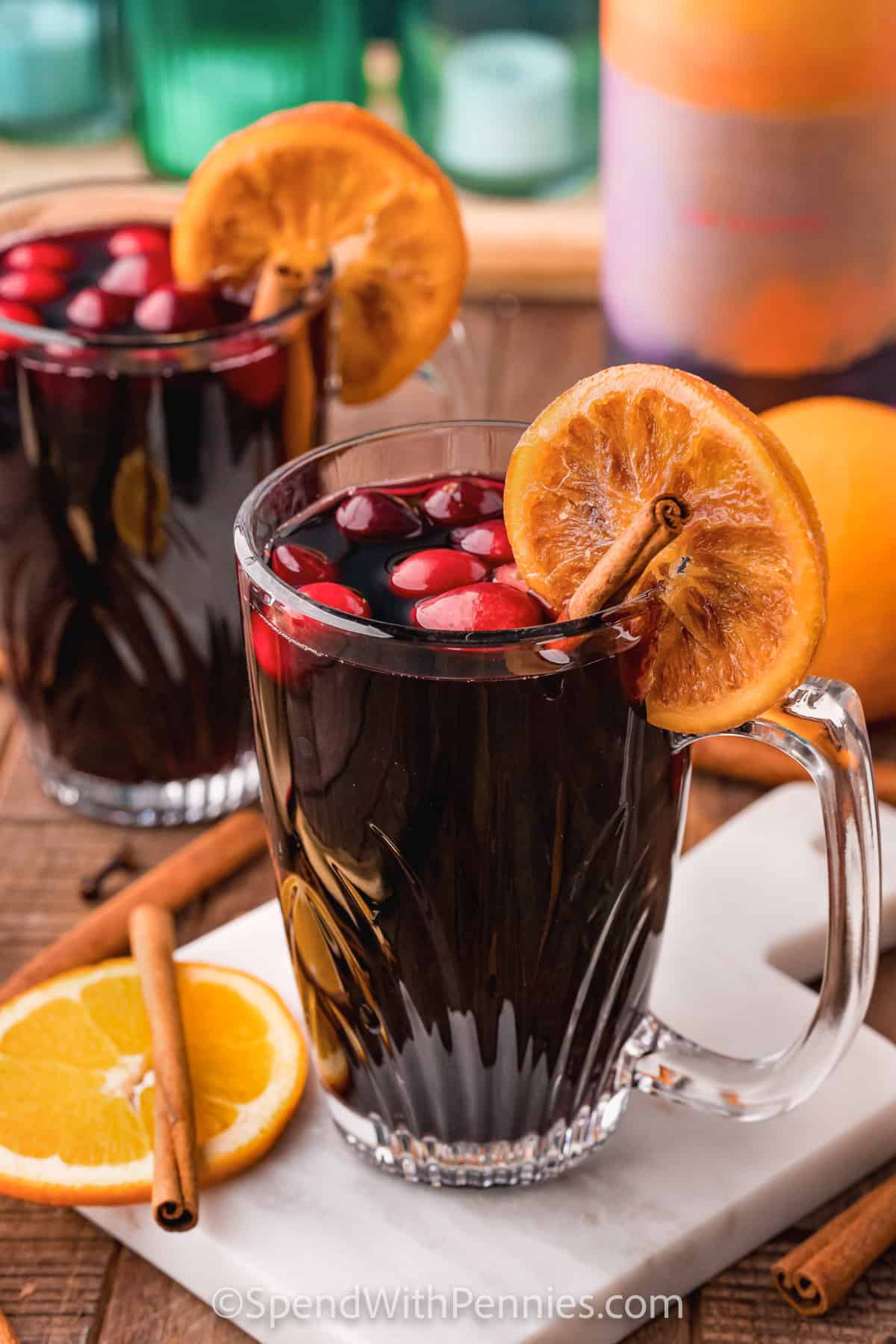 cups of Mulled Wine with oranges and cinnamon stick inside