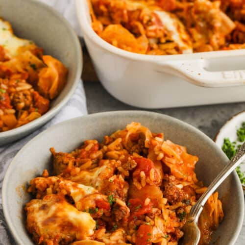 Cabbage Roll Casserole in a bowl with dish full in the back