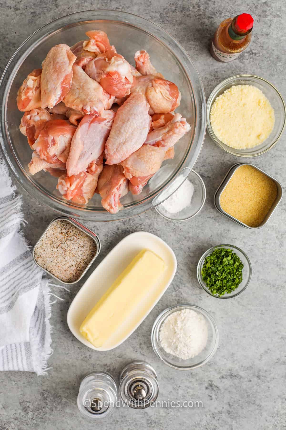 Homemade garlic parmesan chicken wings are one of my favorite chicken wing recipes ever. They are full of delicious flavor, and simple to make in the oven! Bone-in or boneless chicken wings are breaded in a simple flour mixture and baked until crispy. Then toss in a homemade garlic parmesan sauce for the perfect juicy yet crispy bite! #spendwithpennies #garlicparmesanwings #gameday #appetizer ingredients to make Garlic Parmesan Wings