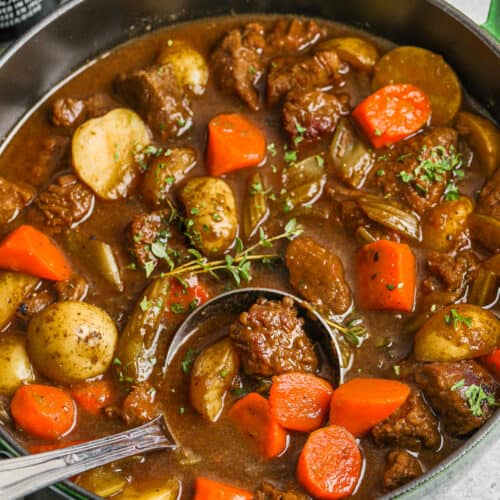a ladle in a pot of Guinness stew