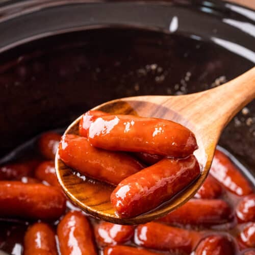 brown sugar bourbon smokies being scooped out of a slow cooker