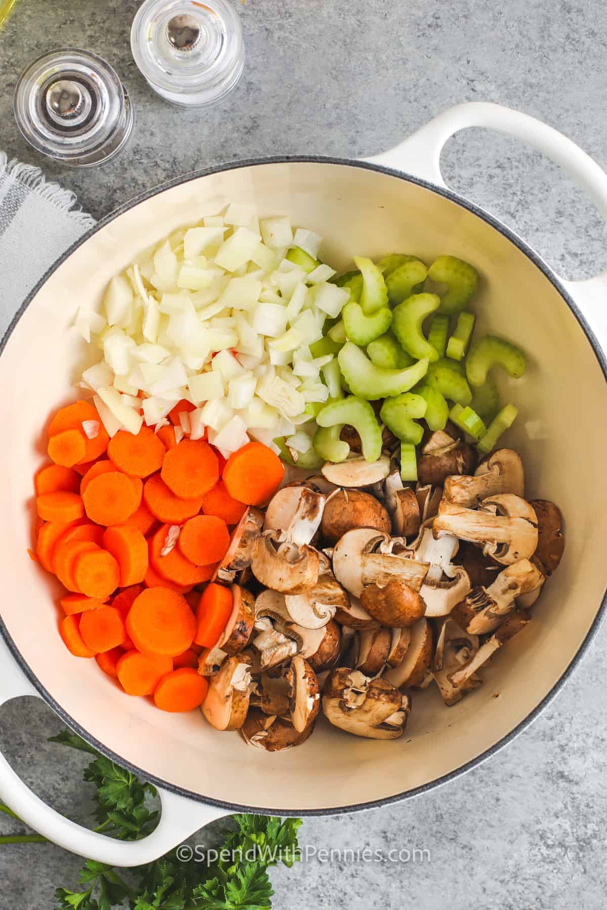 This chicken and mushroom soup is a comforting stovetop recipe that feels like something simmered all afternoon, but it comes together in under an hour. The broth is seasoned with thyme, parsley, and poultry seasoning, then filled with rice, vegetables, and shredded chicken. Use pre-sliced mushrooms or rotisserie chicken to save time. Make it for chilly nights, simple dinners, and cozy leftovers. #spendwithpennies vegetables in a pot to make Chicken Mushroom Soup