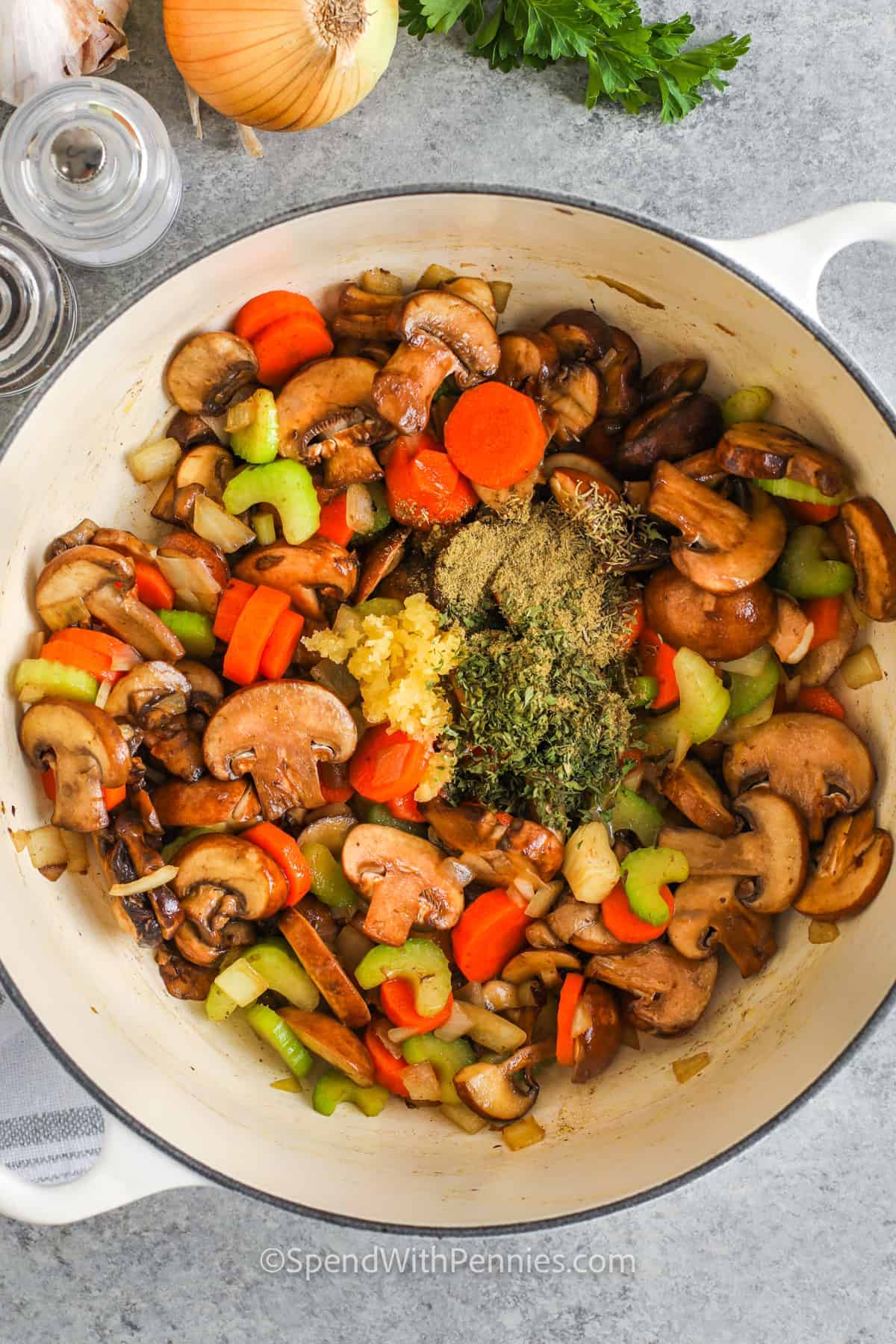 Make chicken and mushroom soup when you want a warm, filling meal without cream or complicated steps. Chicken breasts cook directly in the broth with rice, mushrooms, carrots, celery, onion, garlic, and herbs. The rice makes the soup extra satisfying, while the mushrooms add savory depth. Reheat it with a splash of broth and freeze for quick meals later. #spendwithpennies adding seasonings to vegetables to make Chicken Mushroom Soup