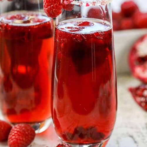 Raspberry Mimosa with a sugar rim and raspberry garnish