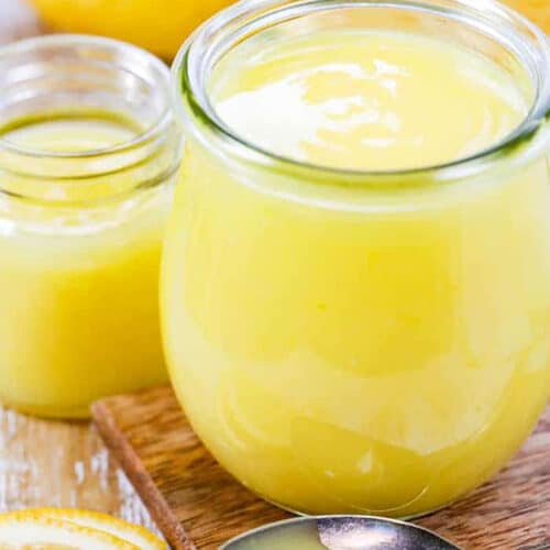 jars of Lemon Curd with lemons in the back