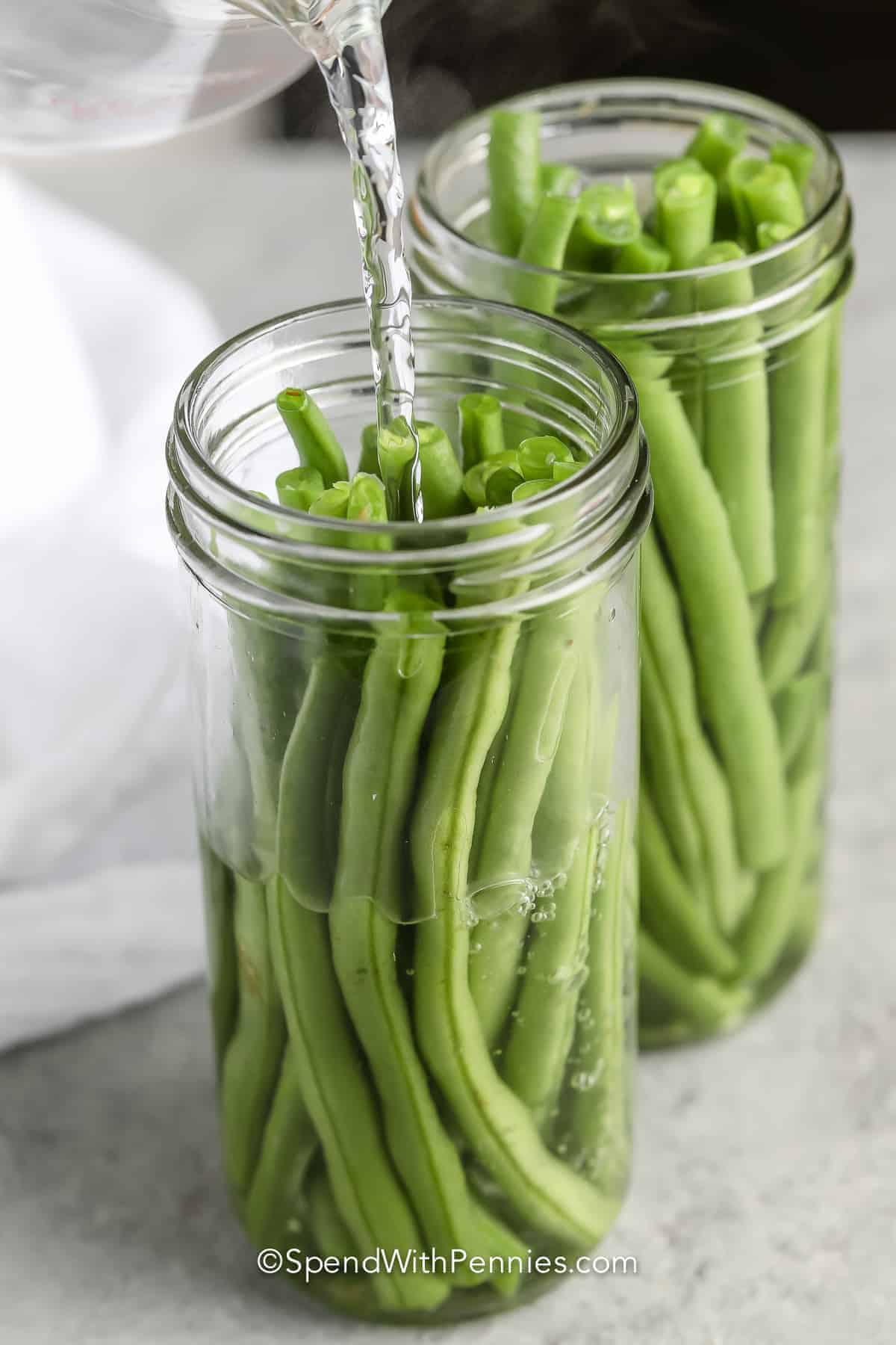 adding vinegar mixture to beans to make Quick Pickled Green beans