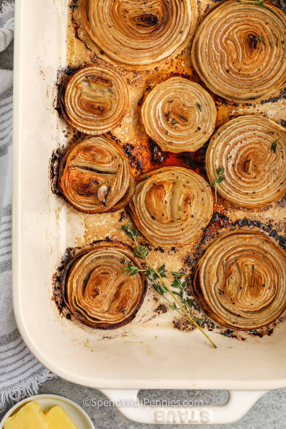 Roasted Onions in a baking dish with thyme