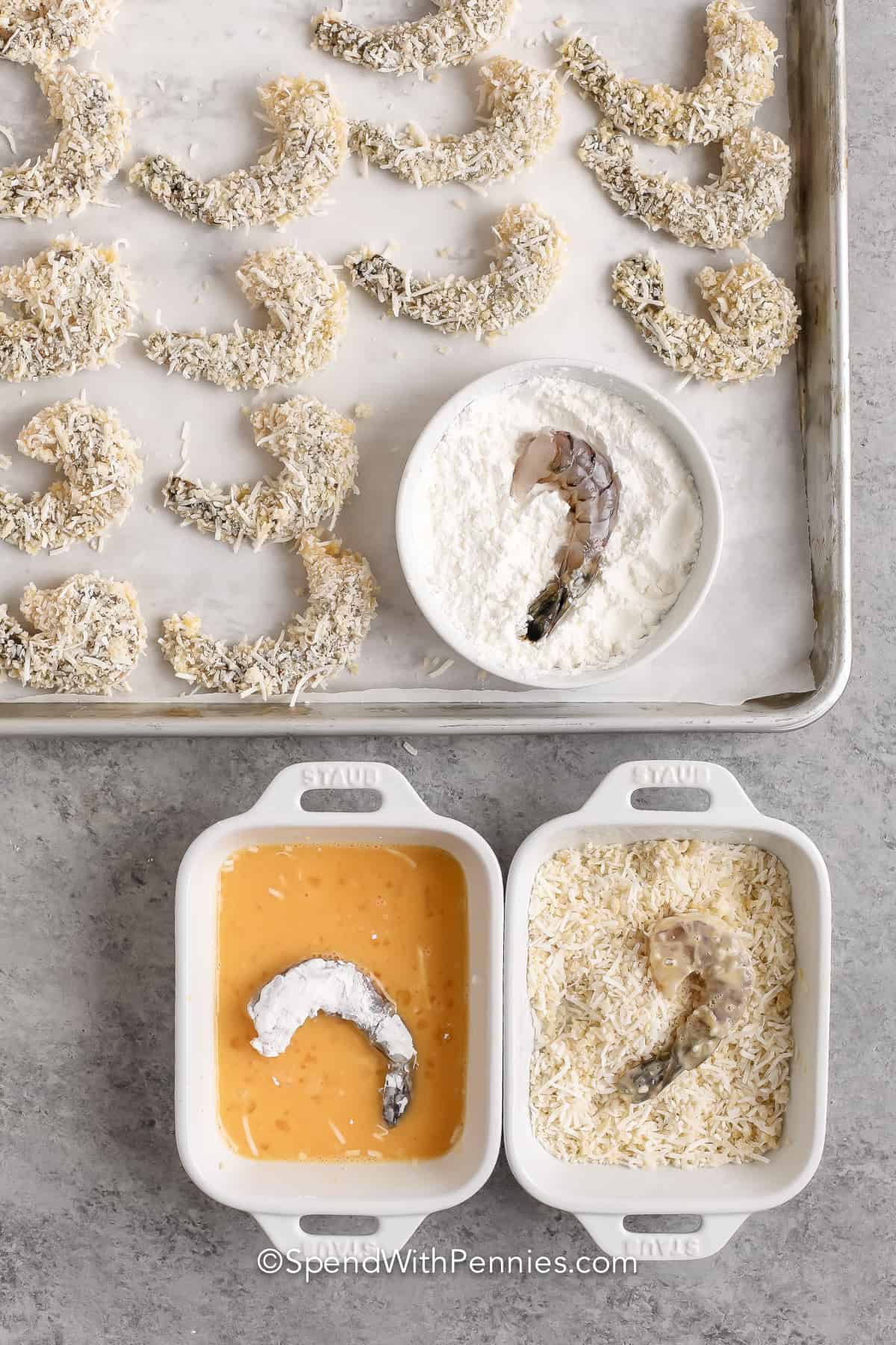 This coconut shrimp is so delectable for dipping in a sweet cocktail sauce. These jumbo shrimp are breaded and cooked to crispy perfection. It is so easy to whip up these coconut shrimp. Guests will love this simple appetizer. #coconutshrimp #coconutshrimprecipe #easycoconutshrimp #spendwithpennies Coconut shrimp being breaded