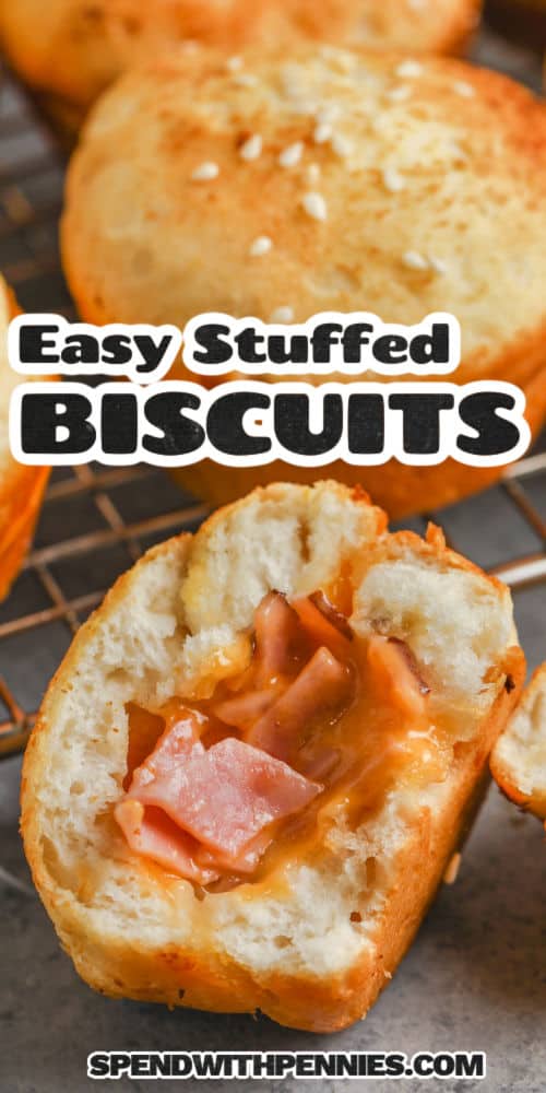 Everyone will love these ham and cheese stuffed biscuits whether they be for lunch or breakfast. Cheddar cheese and ham are stuffed into Pillsbury biscuit dough and then cooked in the oven. Top with gravy, or add a layer of bacon and egg to make a more robust and filling sandwich. #hamandcheesestuffedbiscuits #stuffedbiscuits #biscuits #spendwithpennies open Stuffed Biscuits with writing