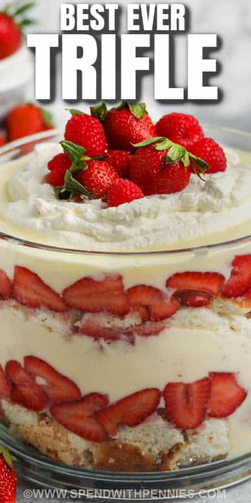 It won't be hard to indulge in this trifle dessert. A cool and creamy custard layered with sweet white cake and topped with whipped cream & strawberries makes for an impressive dessert. This is so easy to make, and everyone will love its sweet decadence. #trifle #triflerecipe #easytrifle #spendwithpennies close up of Trifle with a title