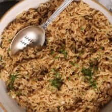 A bowl of seasoned rice with a spoon