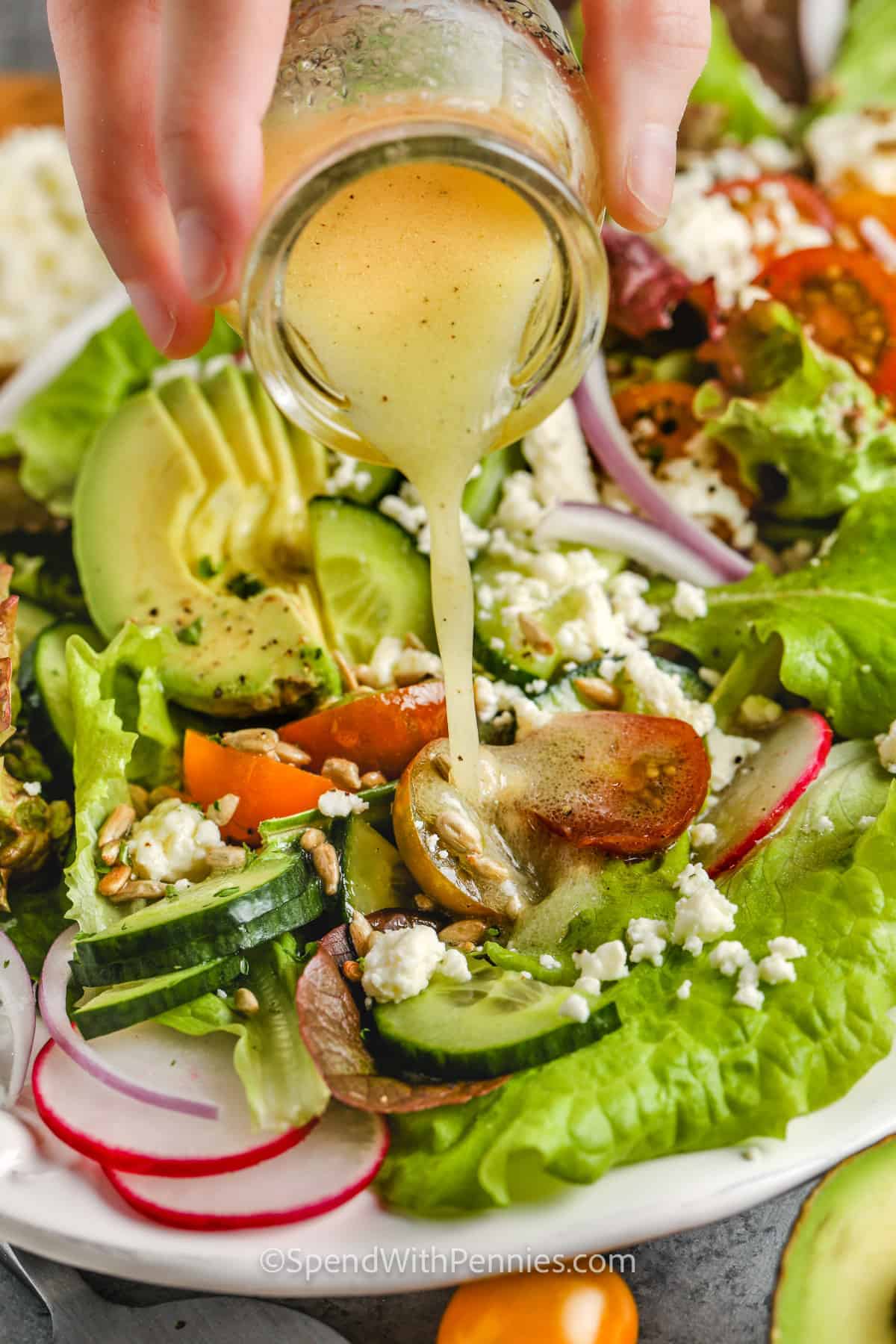 pouring dressing over Summer Salad