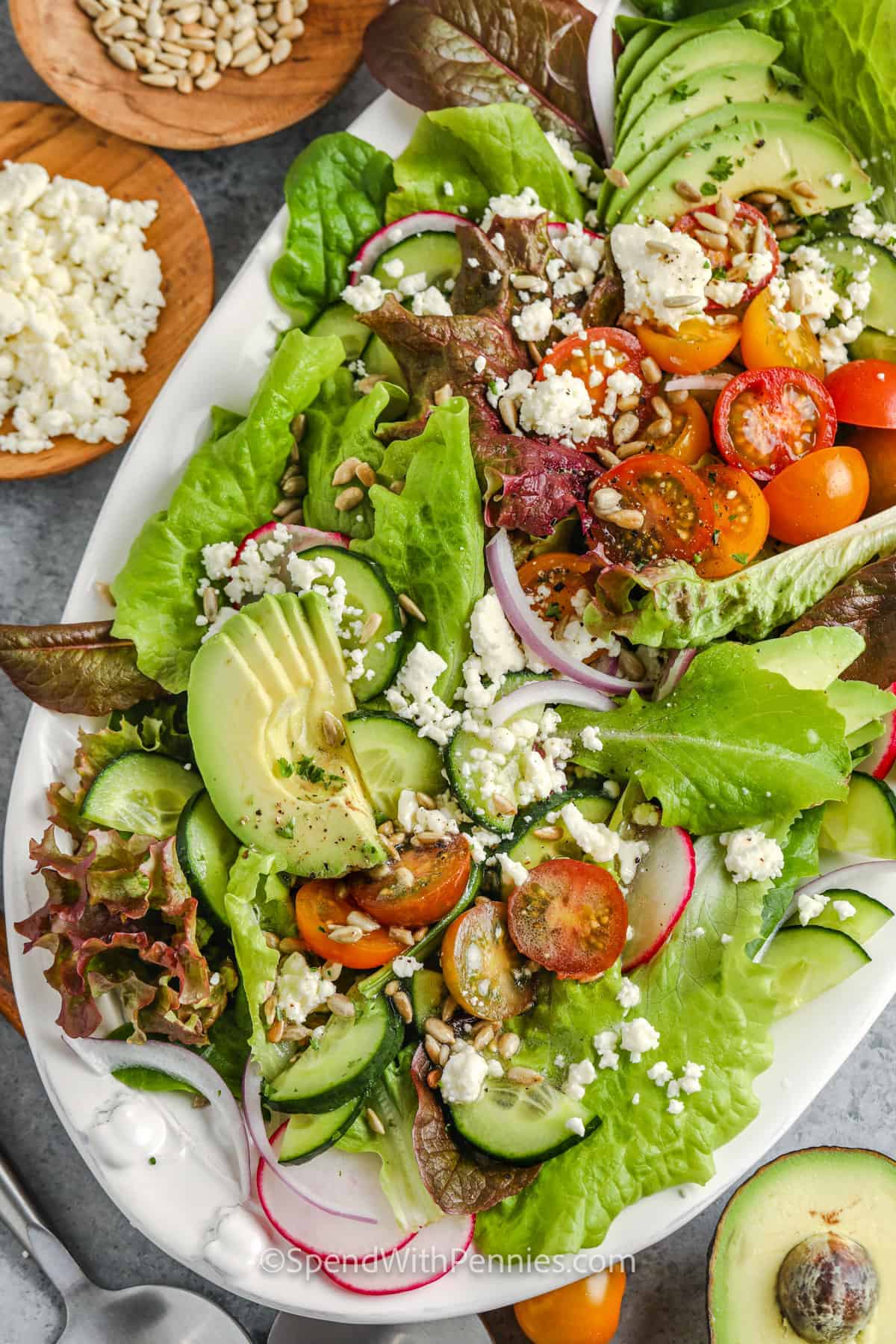 plated Summer Salad with garnish in bowls beside it