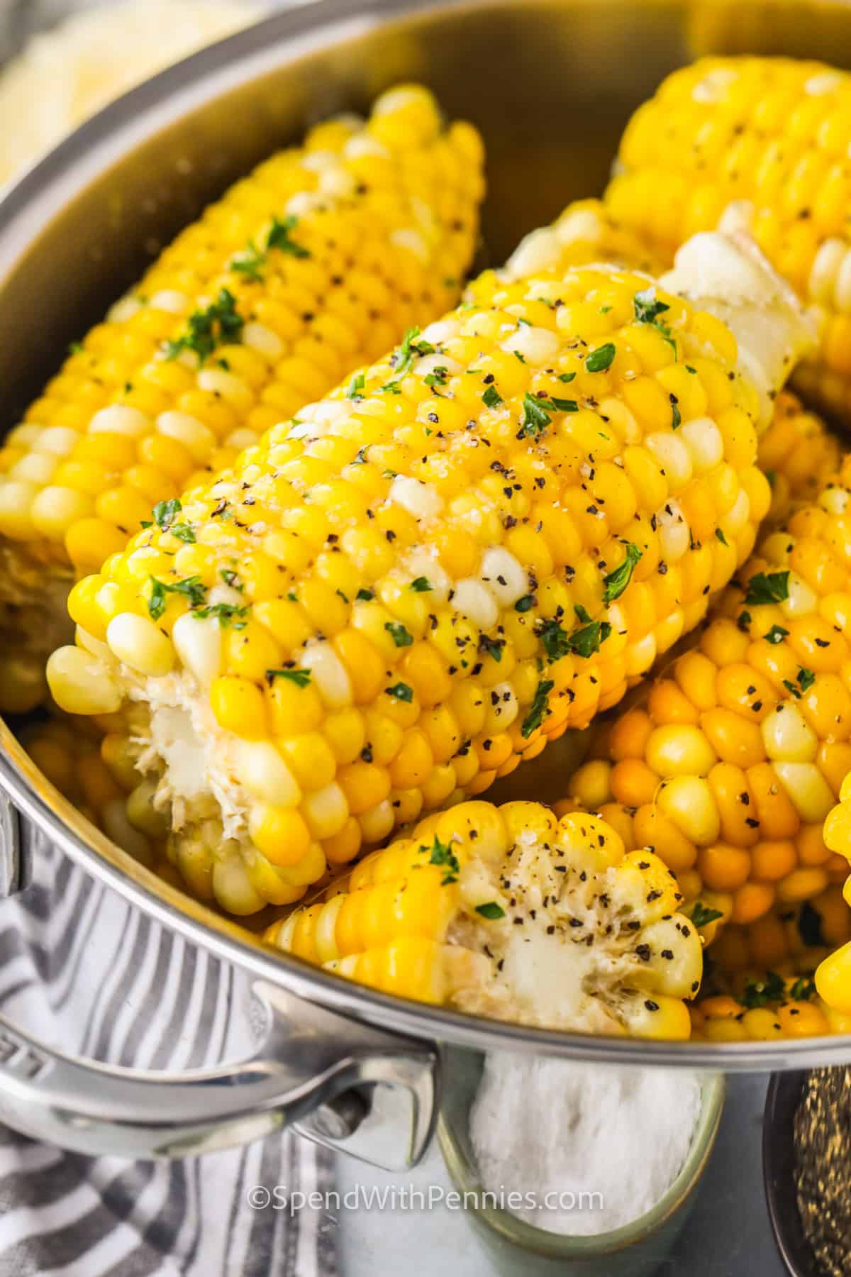 It is so simple and easy to make this boiled corn on the cob recipe. Summer is the best time for serving fresh corn on the cob. This sweet vegetable goes with just about any main dish. Add a little butter, and salt and this veggie will be so hard to resist. #boiledcornonthecob #howtoboilcornonthecob #cornonthecobboiled #spendwithpennies Boiled Corn on the Cob with butter salt and pepper in the pot