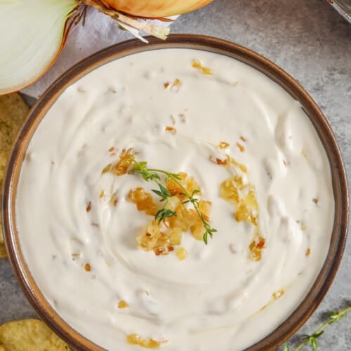 plated French Onion Dip with an onion and chips around it