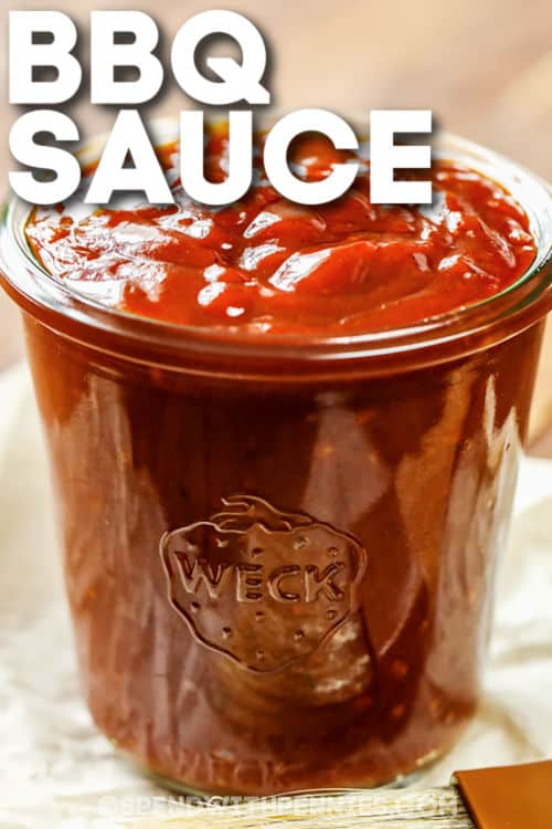 It won't take long to make this BBQ sauce recipe. This is the best recipe for adding to all kinds of dishes. Brush it on to some ribs, BBQ chicken, or for that pulled pork recipe. Adjust the seasoning by making it a little more sweet, spicy, or tart. Whatever you prefer! #BBQsaucerecipe #BBQsauce #barbecuesauce #spendwithpennies close up of Homemade BBQ Sauce with writing