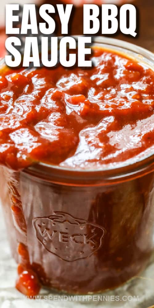 This BBQ sauce recipe has the best combination of all flavors - spicy, sweet, and tart. The great thing about a homemade sauce like this is that it can be easily adjusted to whatever dish is being served. Add some honey to make it a little extra sweet, or spice things up with a dash of Tabasco or sriracha. #BBQsaucerecipe #BBQsauce #barbecuesauce #spendwithpennies close up of jar full of Homemade BBQ Sauce with a title