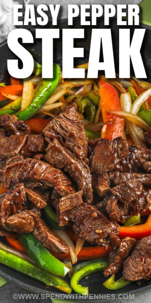 This recipe makes a juicy and tender pepper steak. Simply fry some onions and peppers with a sliced round steak, then cook in an easy-to-make Chinese sauce. This recipe doesn't take long to cook. Serve it over a bed of rice, some ramen noodles, or cauliflower rice! #peppersteak #peppersteakrecipe #easypeppersteak #spendwithpennies close up of cooking Easy Pepper Steak in the pan with a title