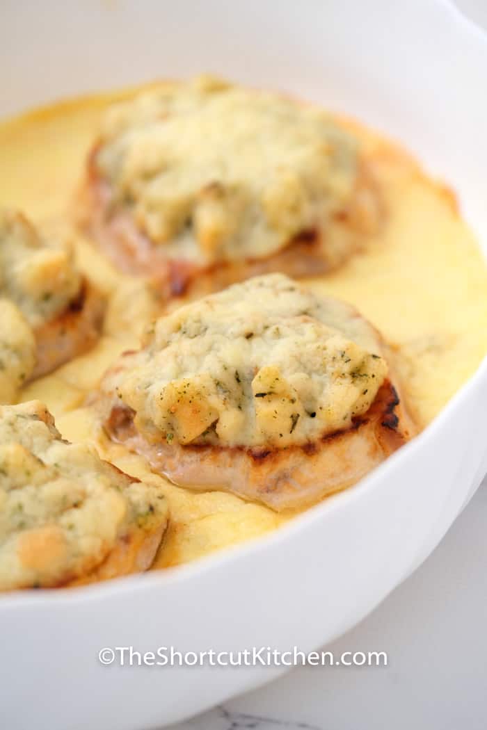 smothered pork chops in a frying pan