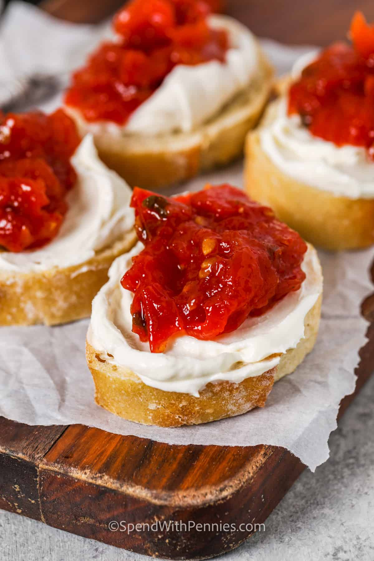 Make a jar of homemade tomato jam. This jam is the best for adding to all kinds of dishes, from omelets to sandwiches. It also only calls for a few simple ingredients like tomatoes, honey, a serrano chili, and some apple cider vinegar. It doesn't get much simpler than that, does it? #tomatojamrecipe #homemadetomatojam #easytomatojam #spendwithpennies Tomato Jam on bread