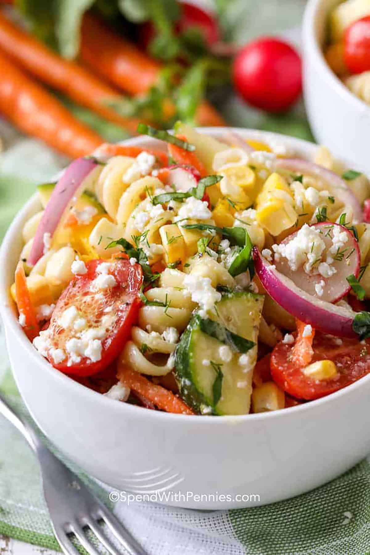 Bring this easy summer pasta salad to the next backyard BBQ or potluck. Made with grape tomatoes and drizzled with a tangy homemade Italian-style dressing, this salad is one for the recipe box. This is so easy to make and is the perfect accompaniment to grilled smokies or sausages, chicken, or steak. #summerpastasalad #recipescoldeasy #recipescoldhealthy #spendwithpennies plated Summer Pasta Salad