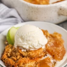 Apple Dump Cake on a plate with ice cream and apples