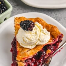 Blackberry Pie slice on a plate with ice cream