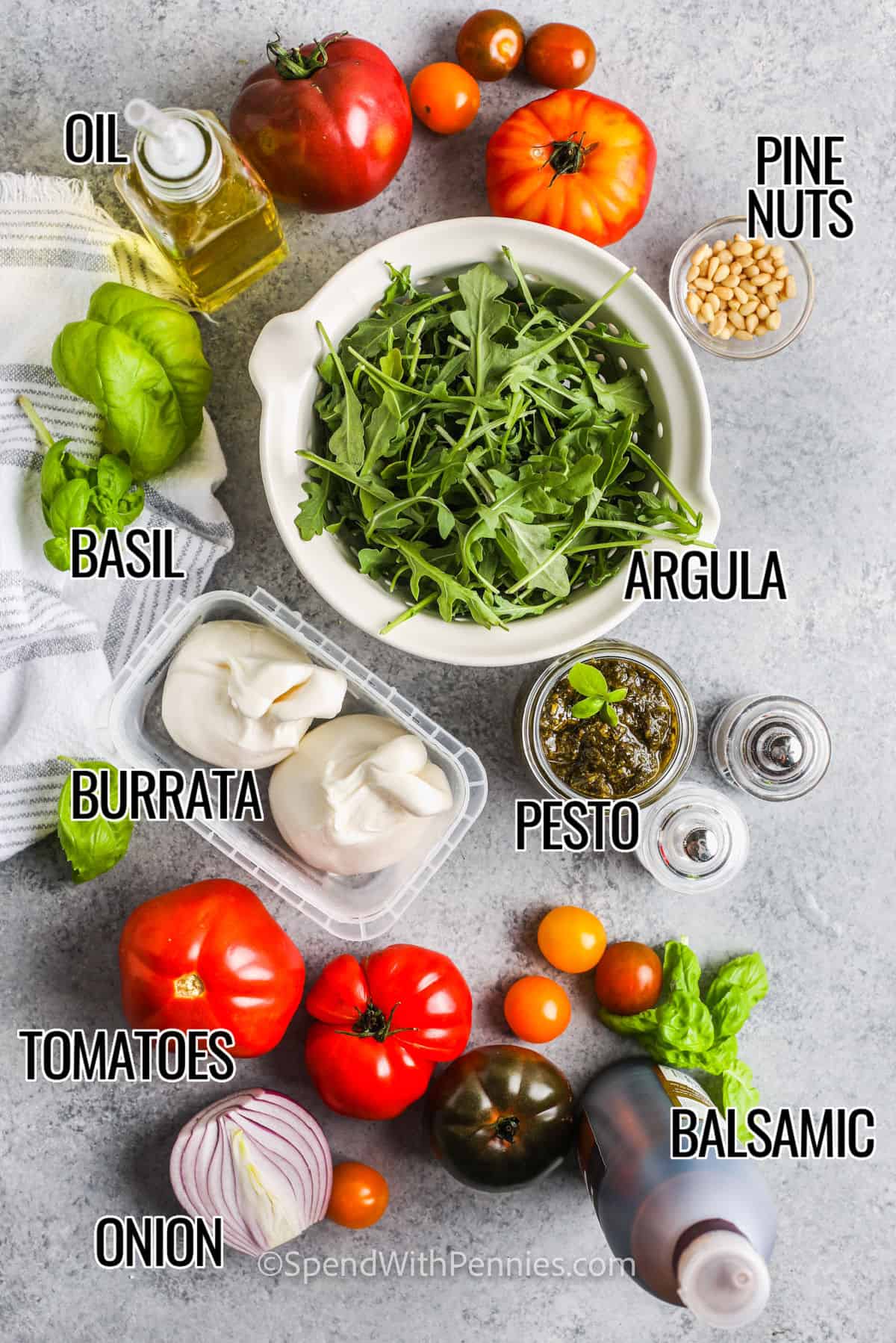 This burrata salad is a delicious gourmet-level recipe that is sure to get rave reviews. It is so easy to make this salad with different ingredients, too. Try a version with grilled peach and tomato, or go for mixed greens and watermelon. Served with a pasta entree and some garlic bread, this salad is always a hit, and it's so simple to make. #burratasalad #arugula #tomato #spendwithpennies argula , pine nuts , basi , oil , balsamic and vegetables to make Tomato Burrata Salad with labels